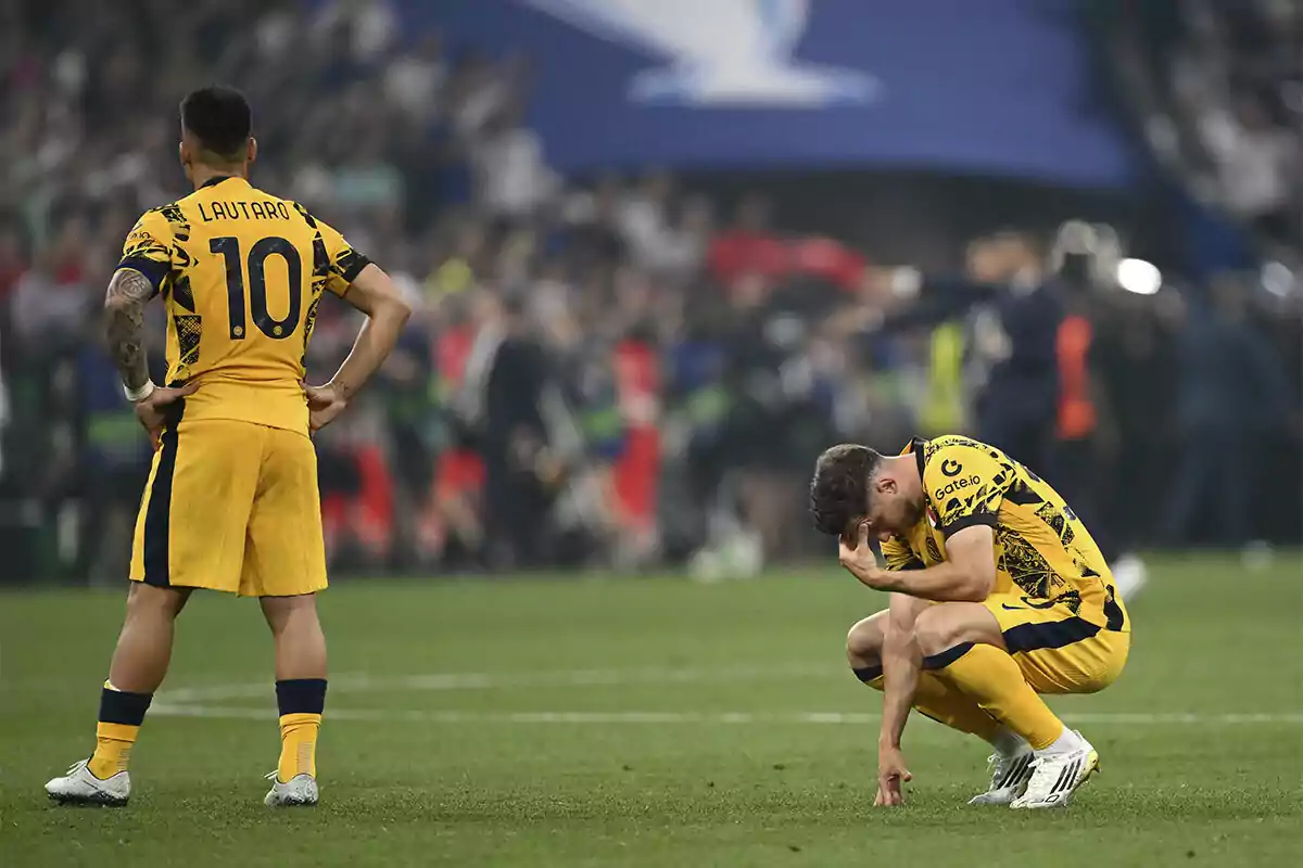 Two players in yellow uniforms show gestures of disappointment on the field after an important match. Two players in yellow uniforms show gestures of disappointment on the field after an important match.