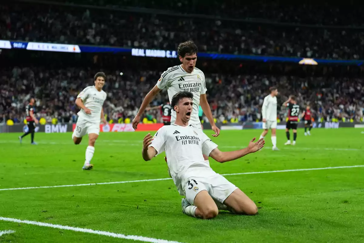 Soccer players celebrating a goal in a stadium full of spectators. Soccer players celebrating a goal in a stadium full of spectators.