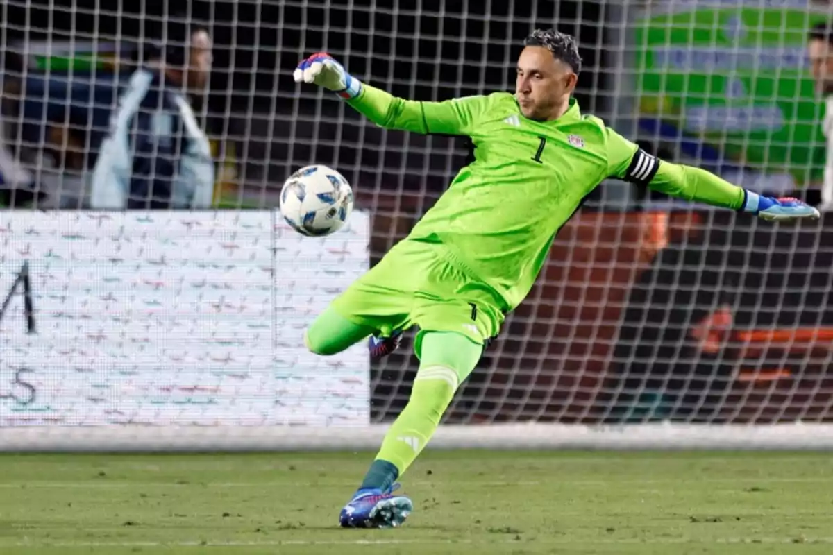 Soccer goalkeeper dressed in green kicking a ball during a match in front of the goal