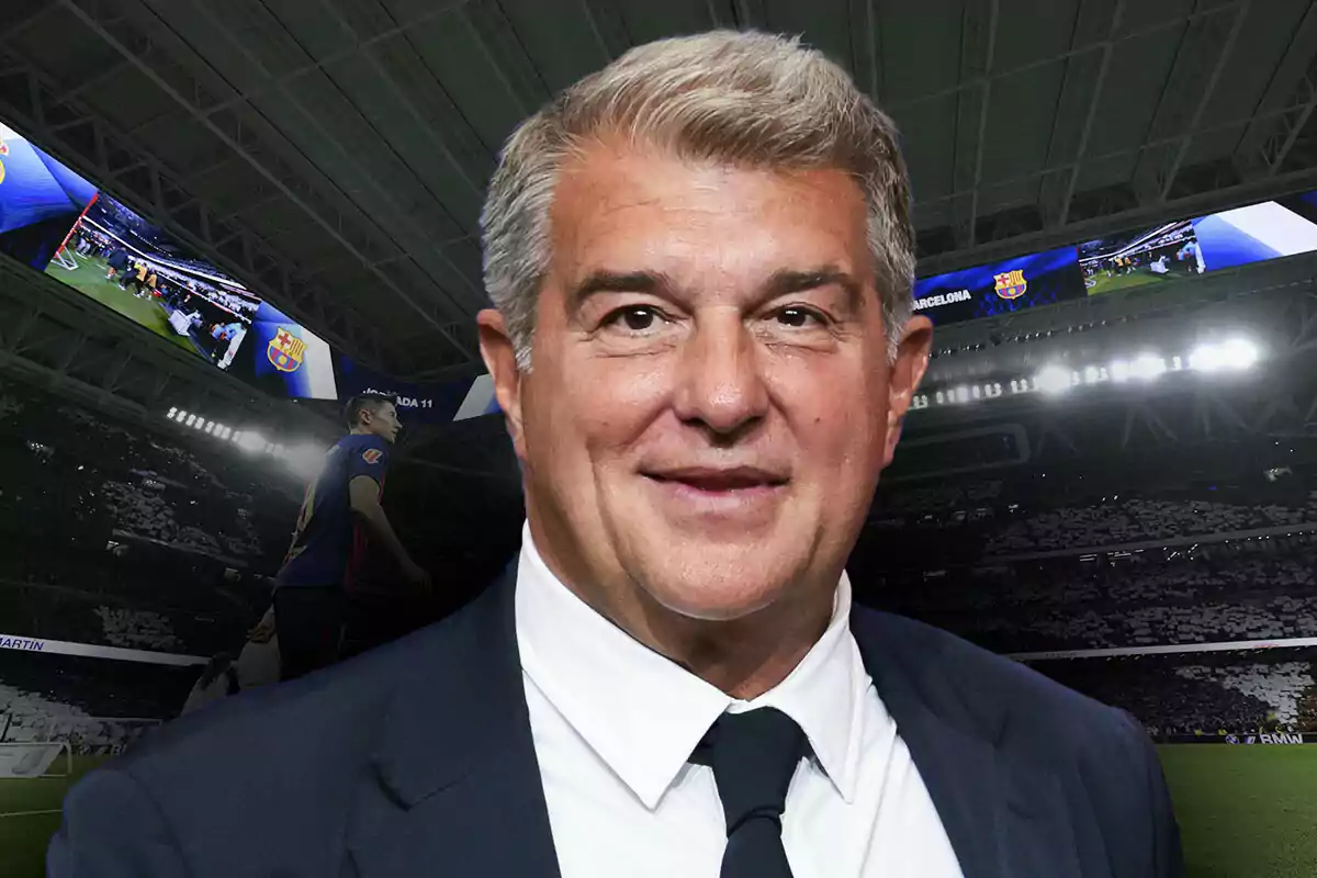 Laporta in a suit and tie in a floodlit soccer stadium.