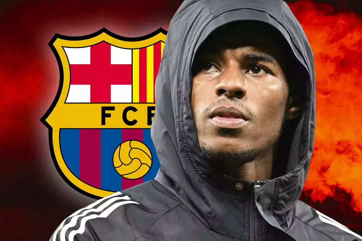 Marcus Rashford in a black hood in front of the FC Barcelona crest on a red background.