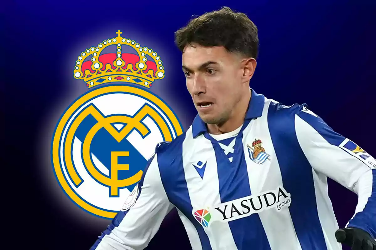 Un jugador de fútbol con el uniforme de la Real Sociedad aparece frente al escudo del Real Madrid.