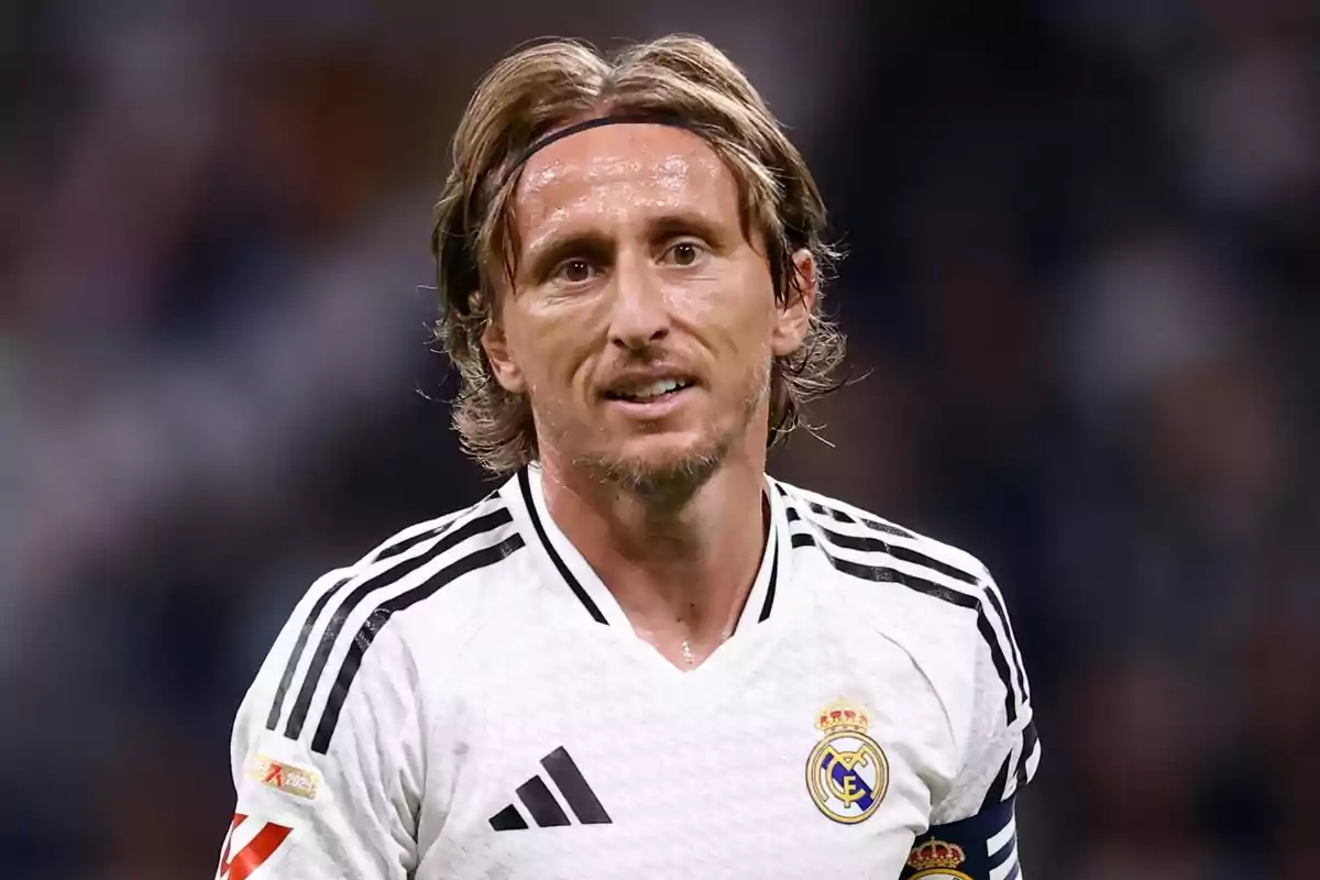 A soccer player in a black and white Real Madrid uniform on the field. A soccer player in a black and white Real Madrid uniform on the field.