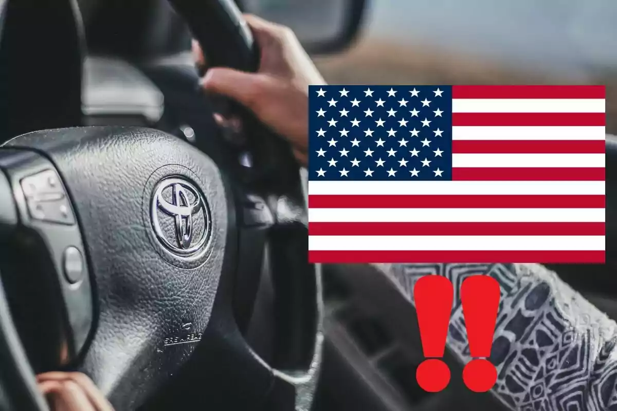 Persona conduciendo un auto Toyota con una bandera de Estados Unidos y dos signos de exclamación rojos superpuestos