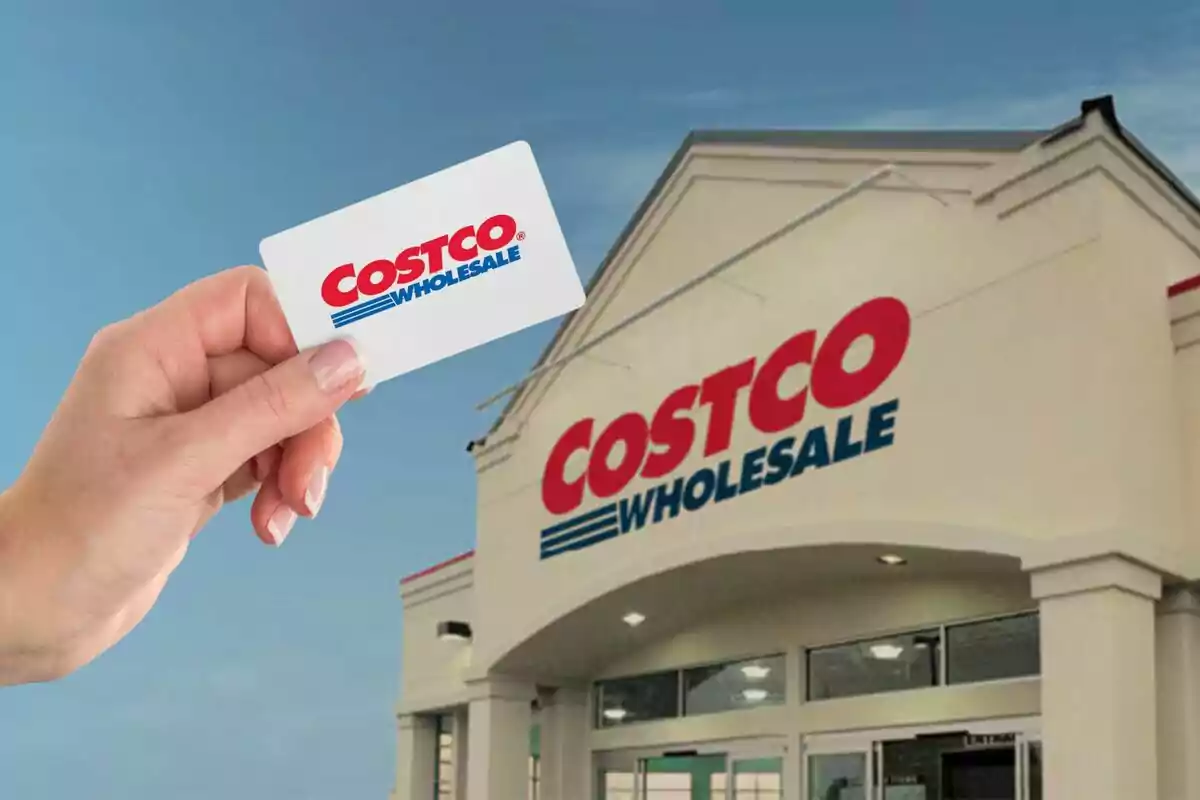 Person holding a membership card in front of the entrance to a Costco Wholesale store. Person holding a membership card in front of the entrance to a Costco Wholesale store.