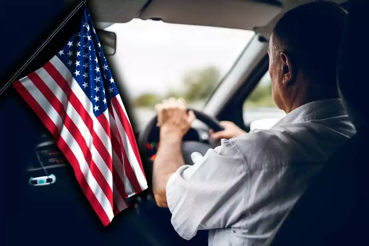 Hombre conduciendo un automóvil con una bandera de Estados Unidos colgada en el interior del vehículo.