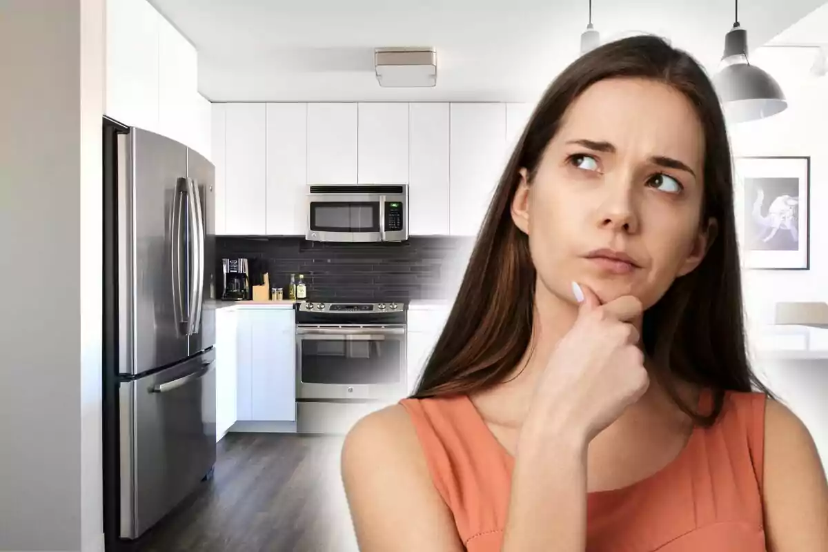 A thoughtful woman in a modern kitchen with stainless steel appliances. A thoughtful woman in a modern kitchen with stainless steel appliances.