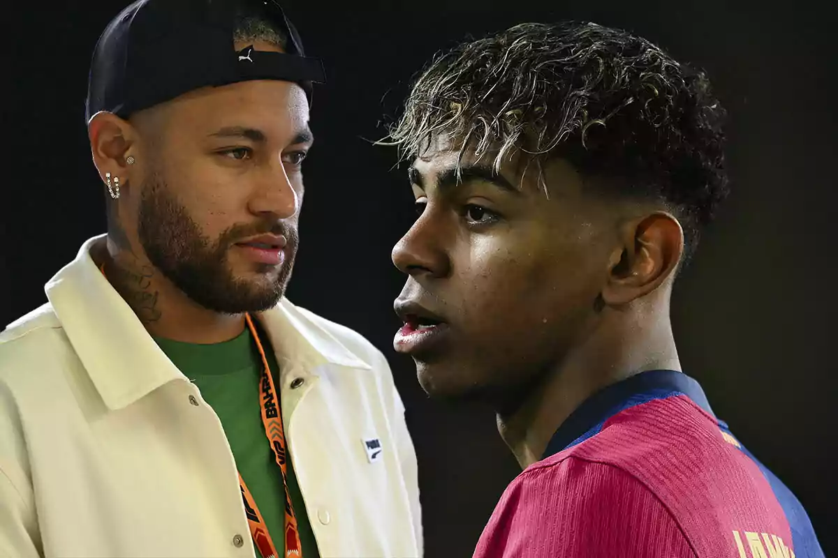 Two men looking at each other in profile, one wearing a cap and a light jacket, the other wearing a sports jersey.