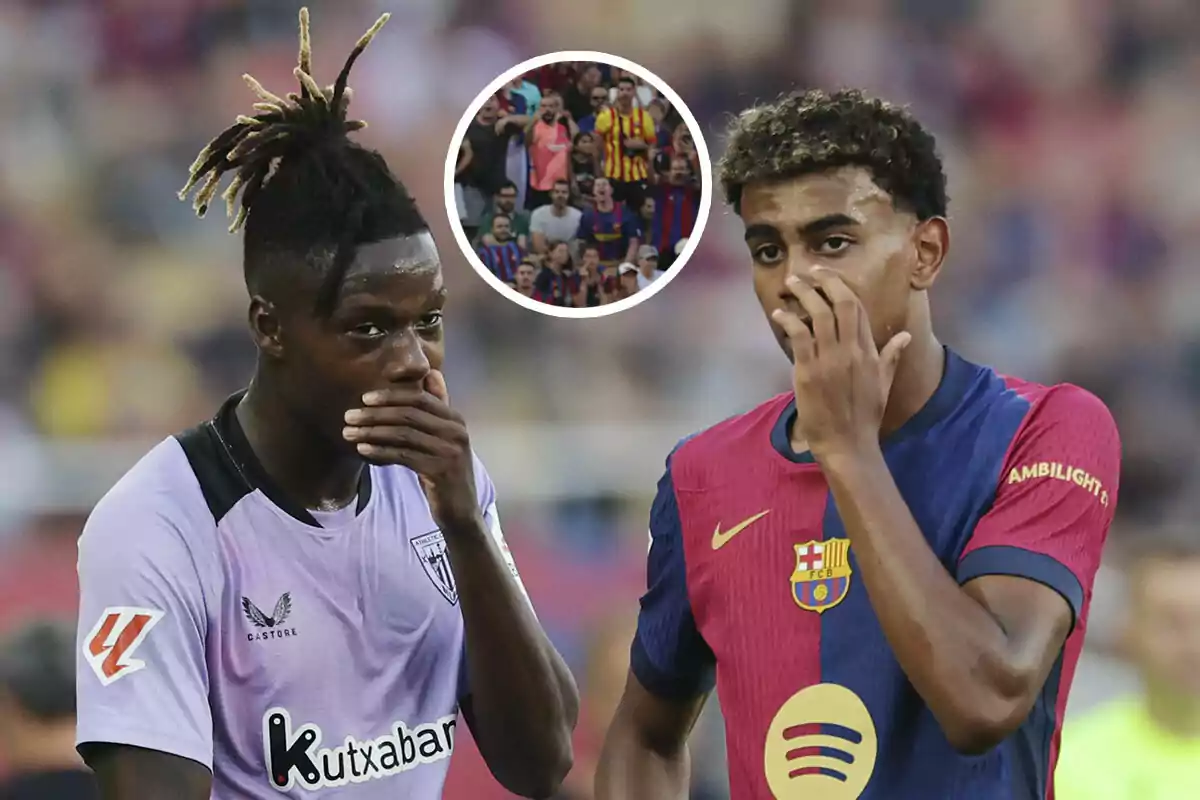 Dos jugadores de fútbol en el campo, Nico Williams con el uniforme del Athletic Club y Lamine Yamal con el del FC Barcelona, se cubren la boca mientras conversan, con una multitud de aficionados en el fondo.