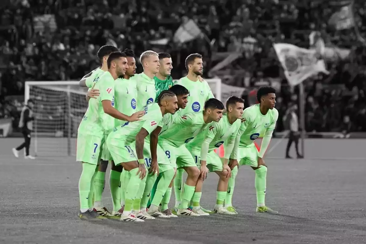A soccer team posing on the field in fluorescent green uniforms. A soccer team posing on the field in fluorescent green uniforms.