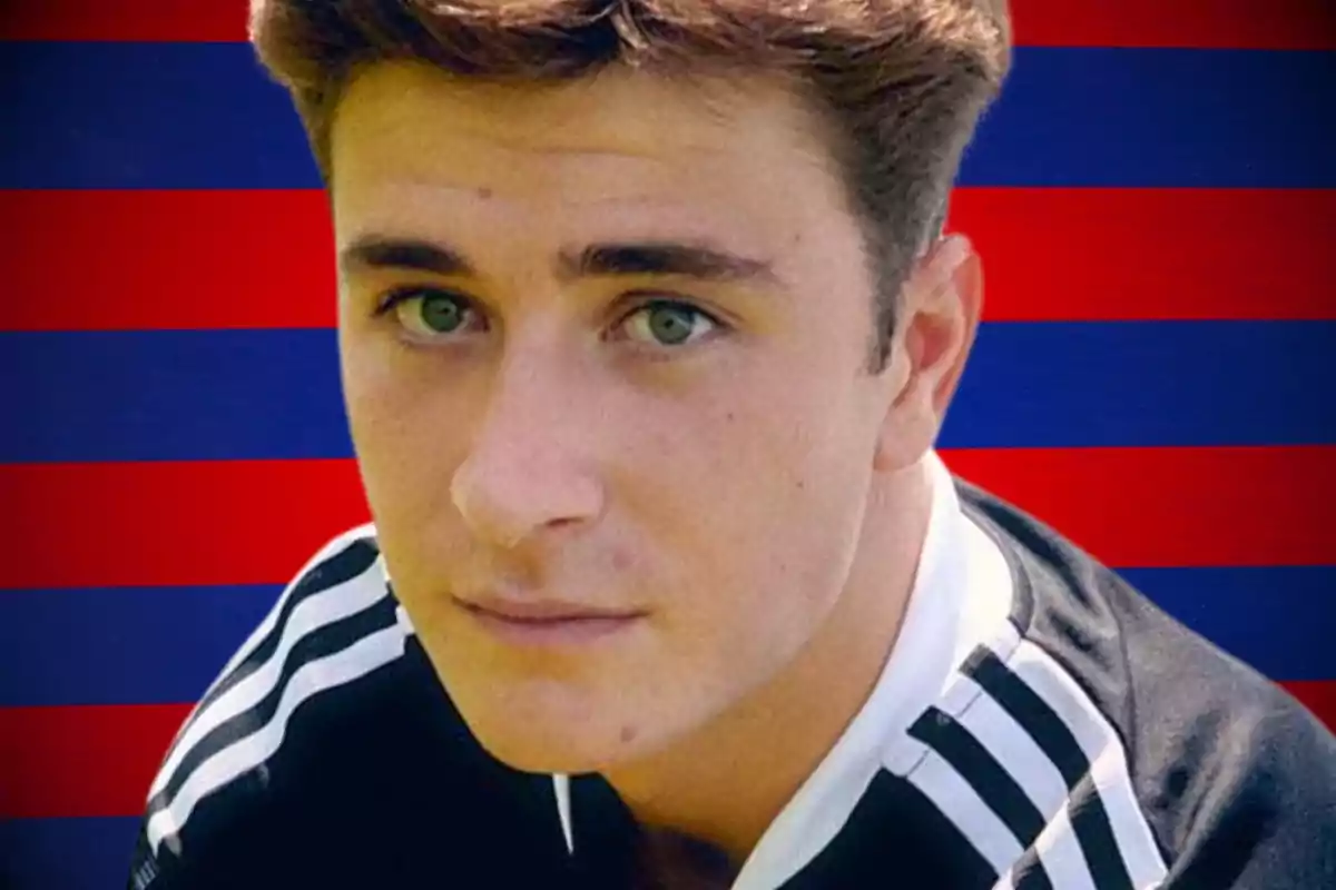 A young man in a black and white sports shirt in front of a red and blue striped background.