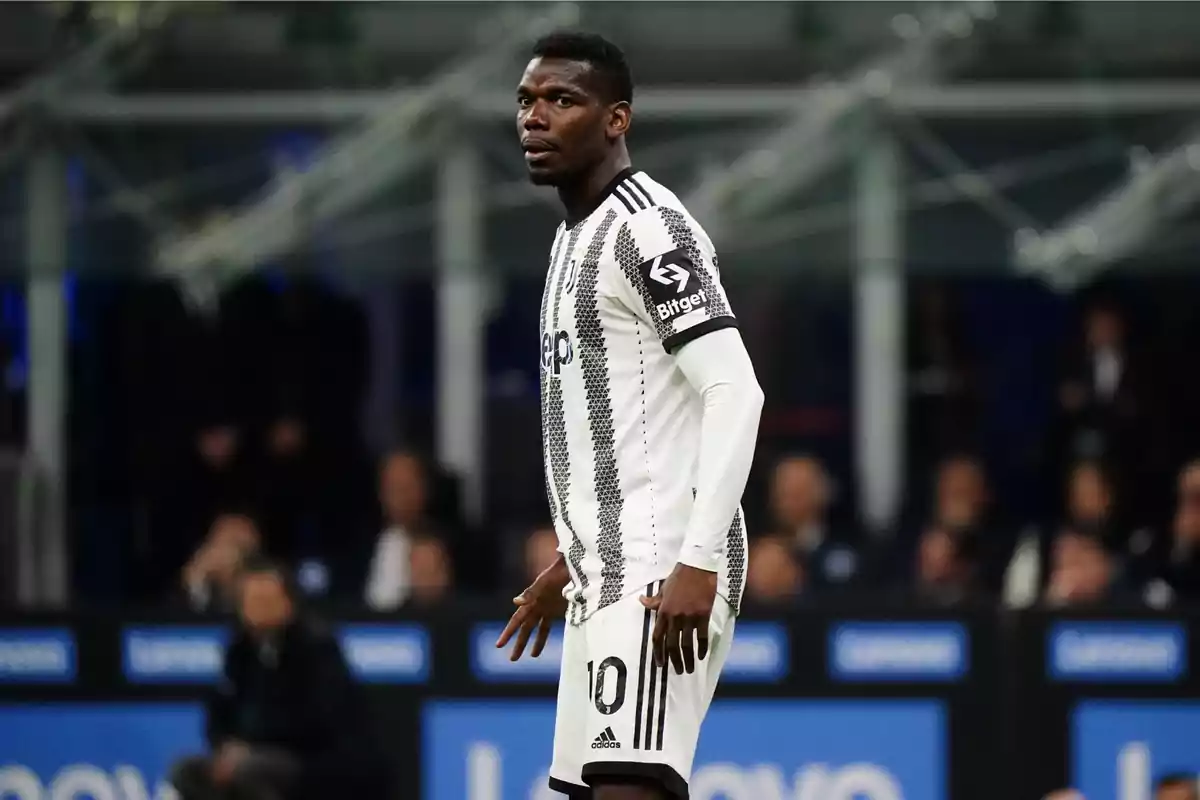 A soccer player in a black and white uniform on the field during a match.