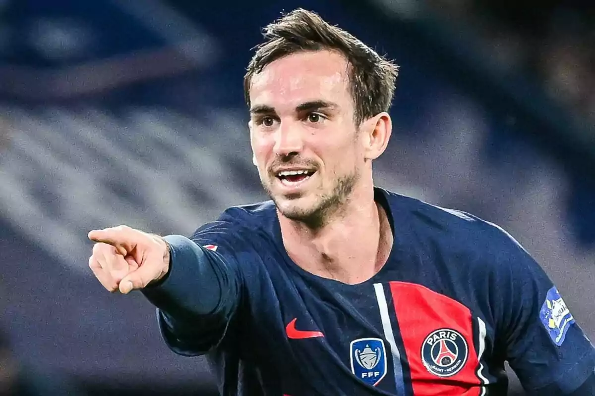 Soccer player in Paris Saint-Germain uniform pointing his finger.