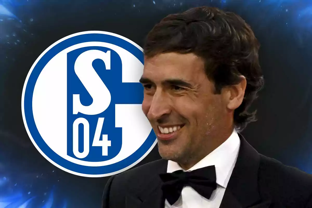 Smiling man in a tuxedo in front of the Schalke 04 club logo