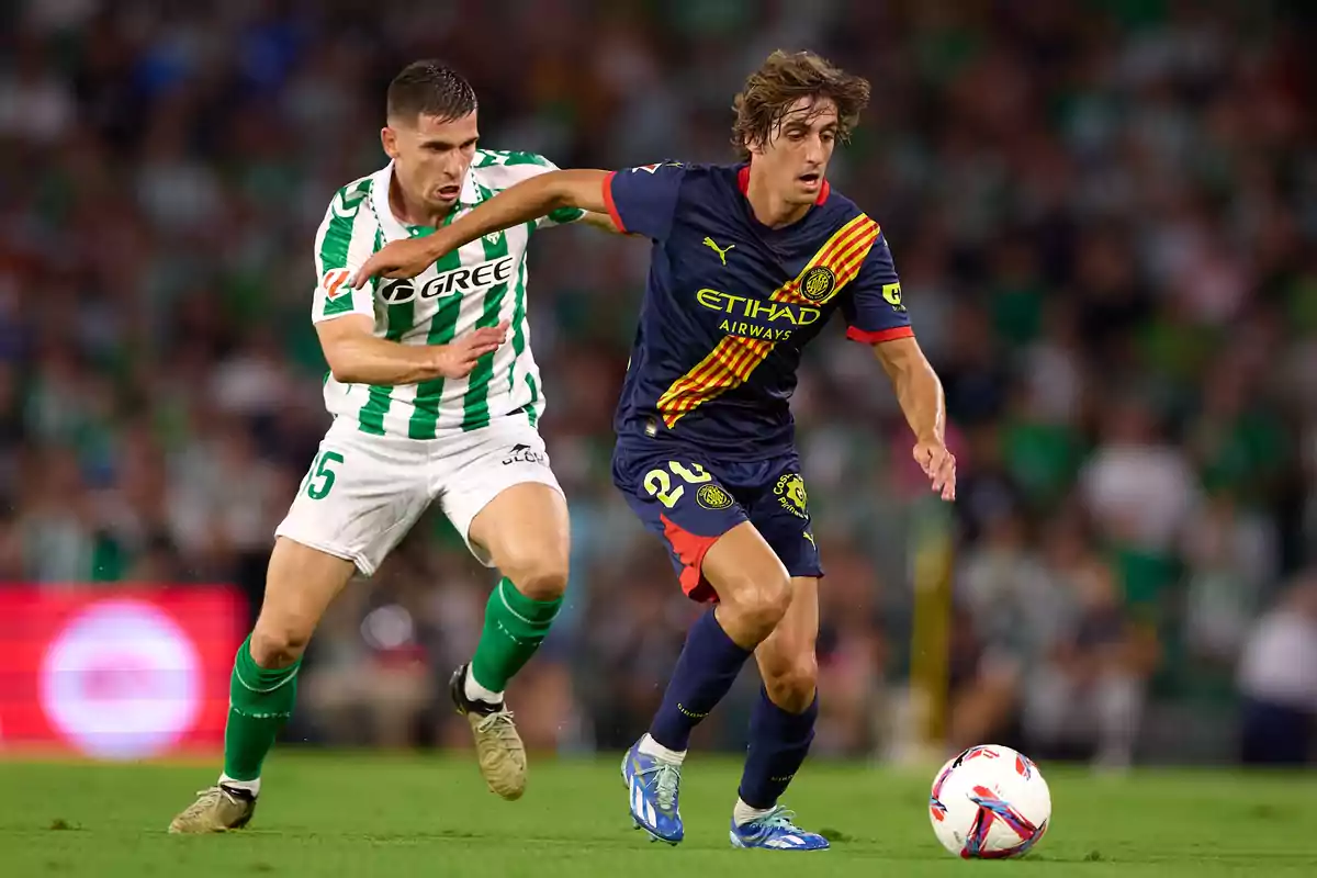 Two soccer players compete for the ball in a game. Two soccer players compete for the ball in a game.