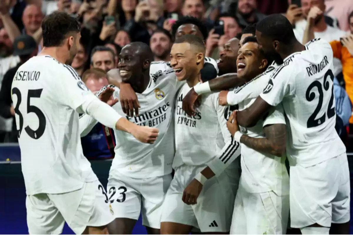 Soccer players celebrating a goal as a team during a match.