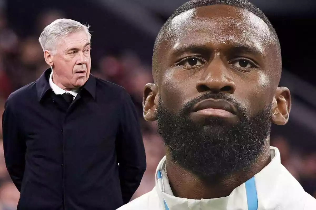 Antonio Rüdiger in the foreground with Carlo Ancelotti next to him looking at him