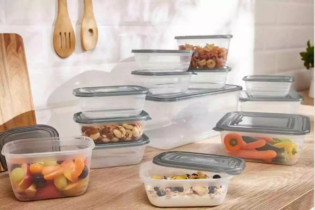 Piece of wooden kitchen counter, full of transparent containers or tapers with gray lids Piece of wooden kitchen counter, full of transparent containers or tapers with gray lids