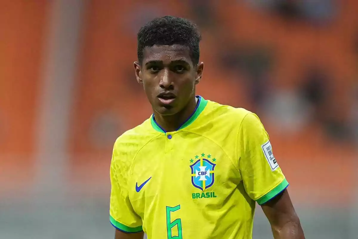 A soccer player in the yellow uniform of Brazil on the field.