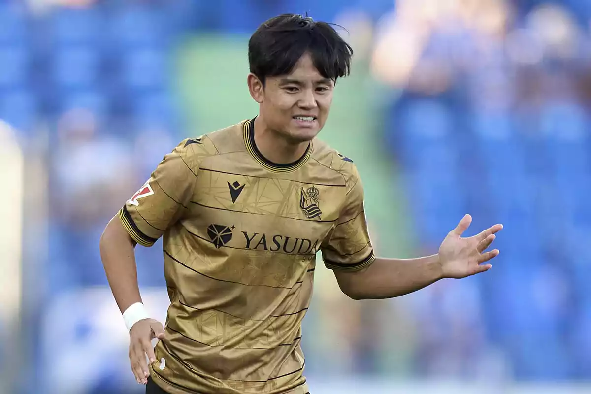 A football player in a gold uniform on the field. A football player in a gold uniform on the field.