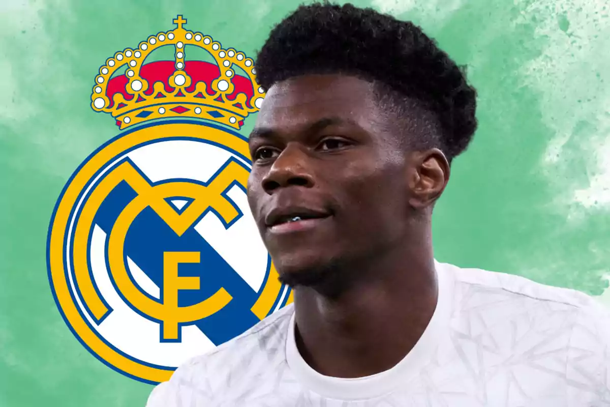 Soccer player in a white jersey in front of the Real Madrid logo on a green background.