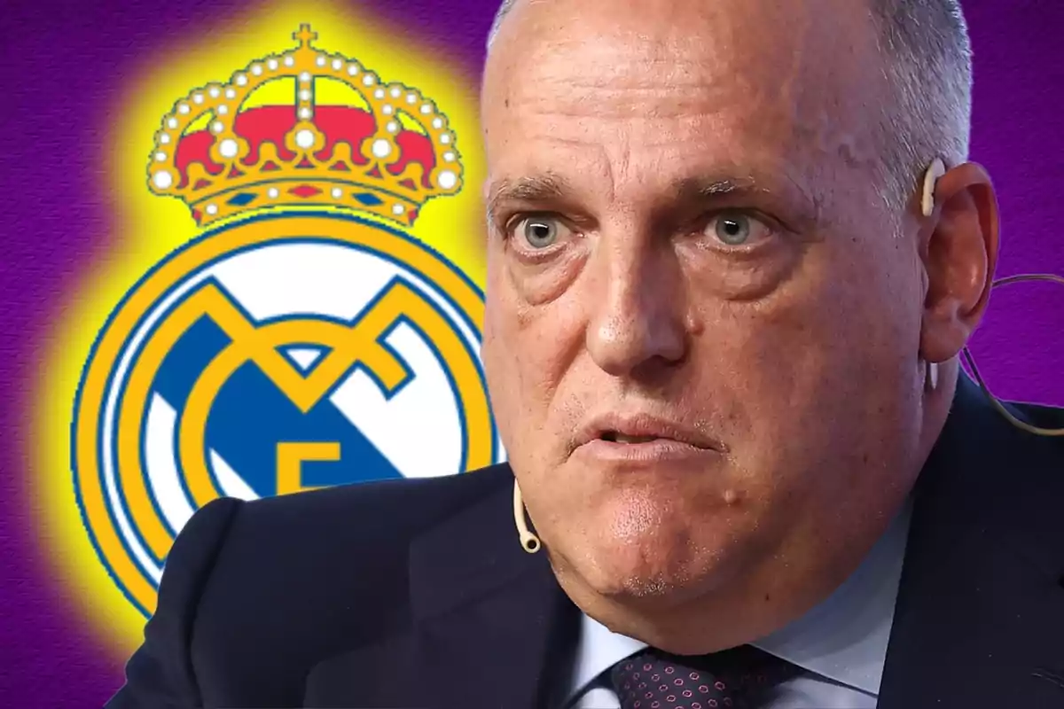 Man with a serious expression and a microphone in his ear, with the Real Madrid shield in the background.