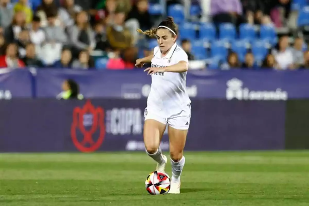 Female soccer player in action during a match in a stadium with fans in the stands. Female soccer player in action during a match in a stadium with fans in the stands.