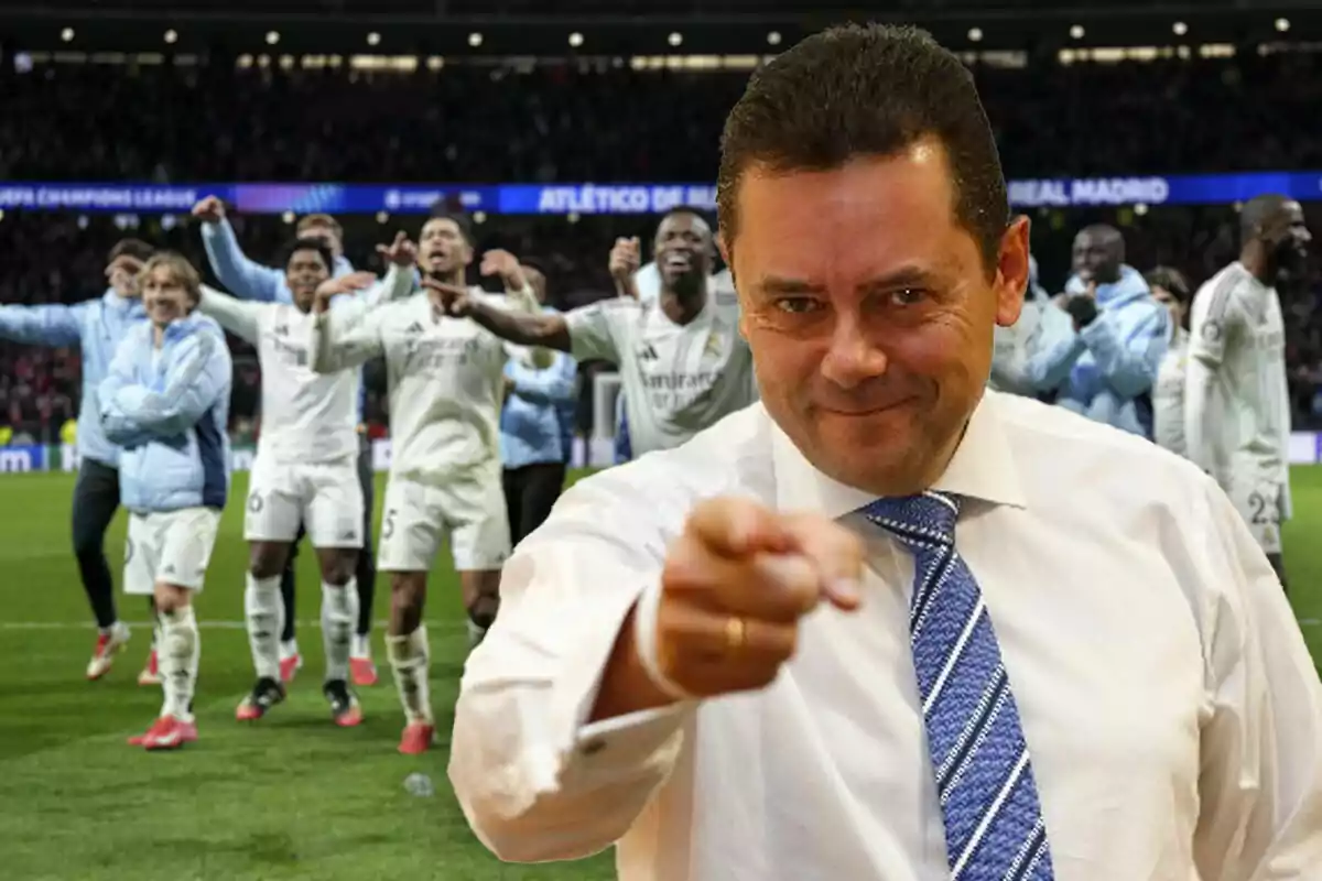 A smiling man points at the camera while a group of players celebrates in the background.