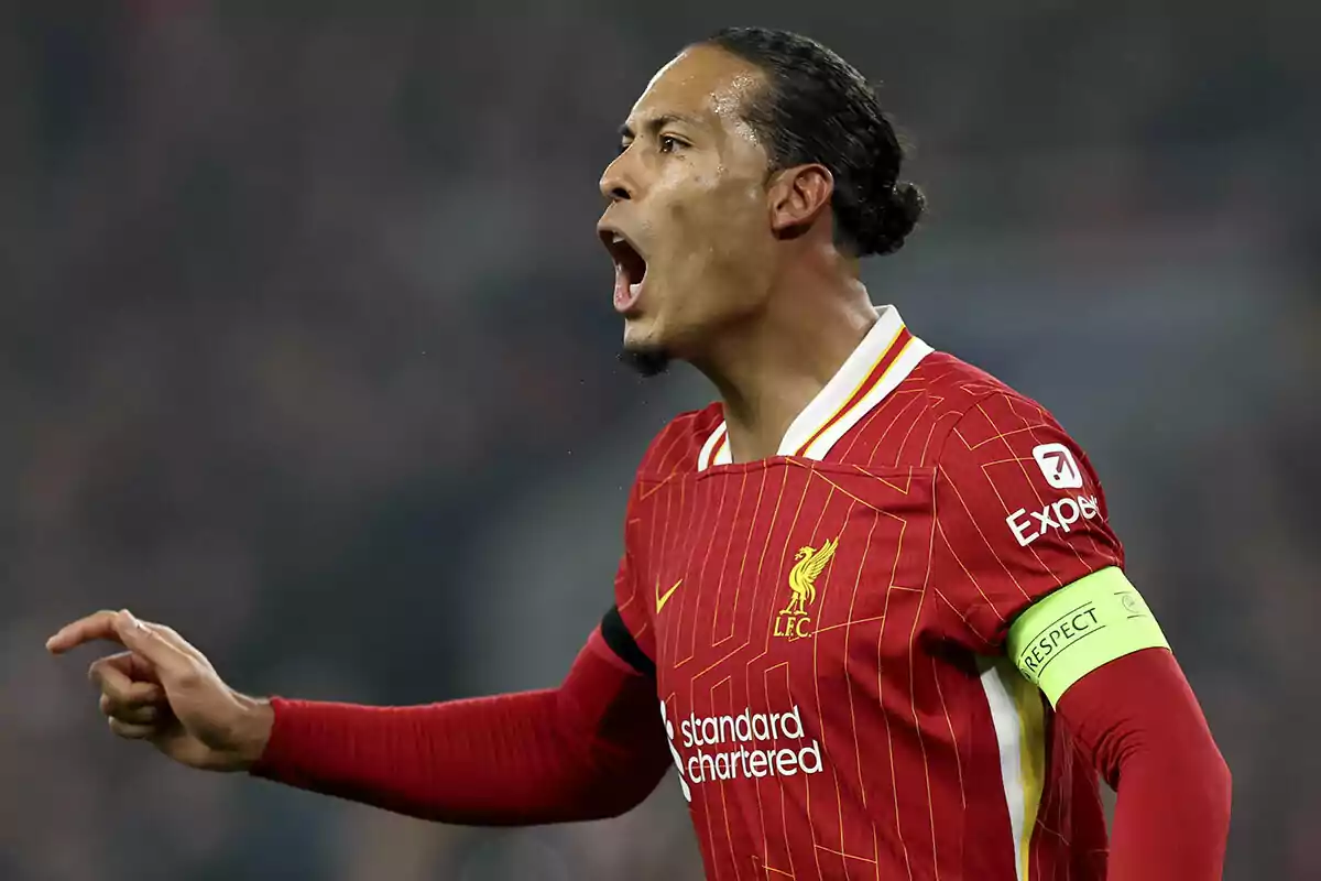 Van Dijk in red uniform gesturing on the field.