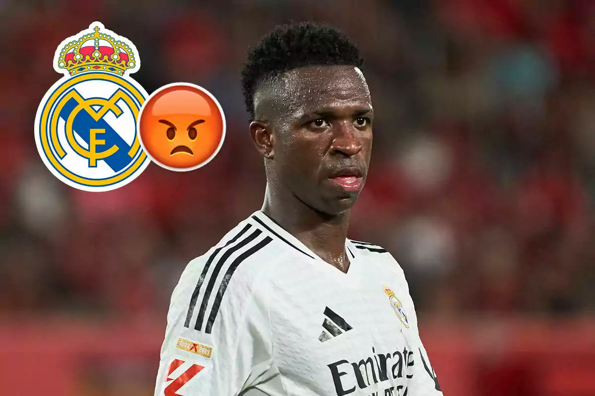 Vinicius del Real Madrid con una expresión seria, junto al escudo del equipo y un emoji de enojo.