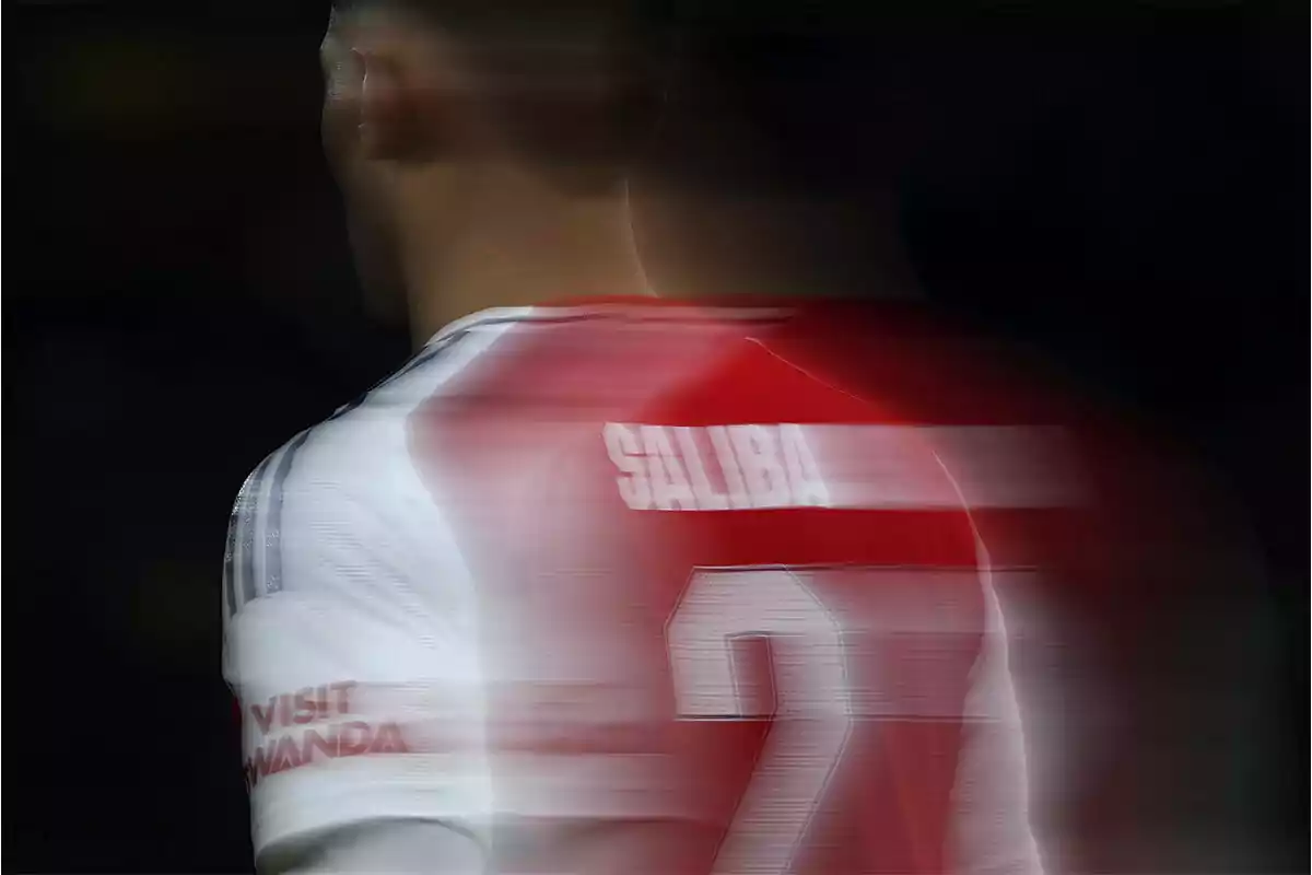 Soccer player with motion effect in the red and white jersey.