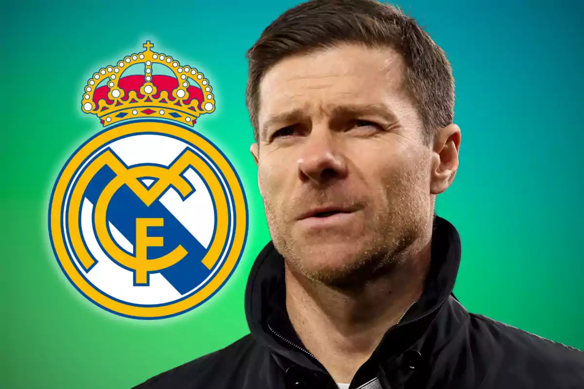 A man in a dark jacket in front of a green background with the Real Madrid crest beside him.